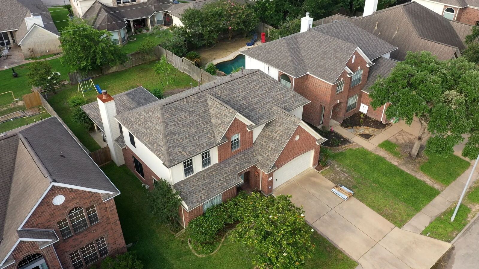 Aerial view of completed roofing projects in a neighborhood